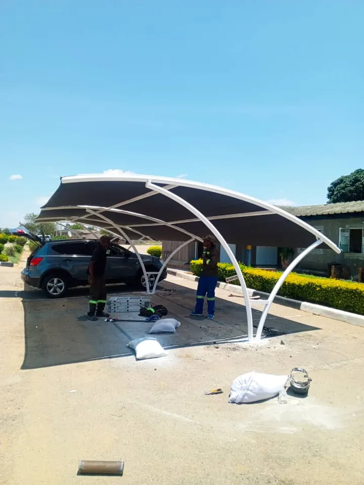 Our team fitting the net to a white curved frame